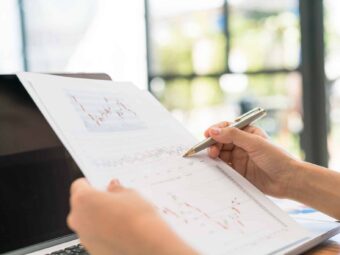 Business woman hand with Financial charts and laptop on the tabl Silberstreif am deutschen Konjunkturhorizont business woman hand with financial charts laptop table Versicherungspapa