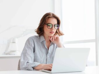 Charming businesswoman in glasses and striped shirt working with BGH stärkt Immobilienverkäufer in Notlagen charming businesswoman glasses striped shirt working with laptop computer while siting home scaled Versicherungspapa