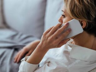Pensive woman talking on the phone while relaxing on the sofa at Wohnungsbau in der Talsohle? distraught woman resting sofa communicating mobile phone scaled scaled Versicherungspapa