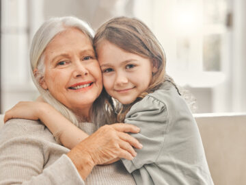 Startseite grandma girl portrait sofa hug love relationship development home senior woman grandchild bonding couch family values womens day weekend relax living room scaled Versicherungspapa