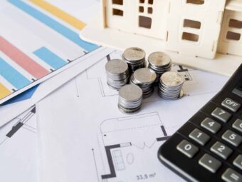BGH stärkt Immobilienverkäufer in Notlagen graph stack coins calculator house model blueprint scaled Versicherungspapa