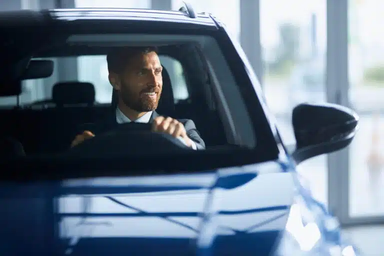 Autobesitzer blieben 2025 weitgehend von Naturgefahren verschont businessman suit buying new car modern salon scaled Versicherungspapa