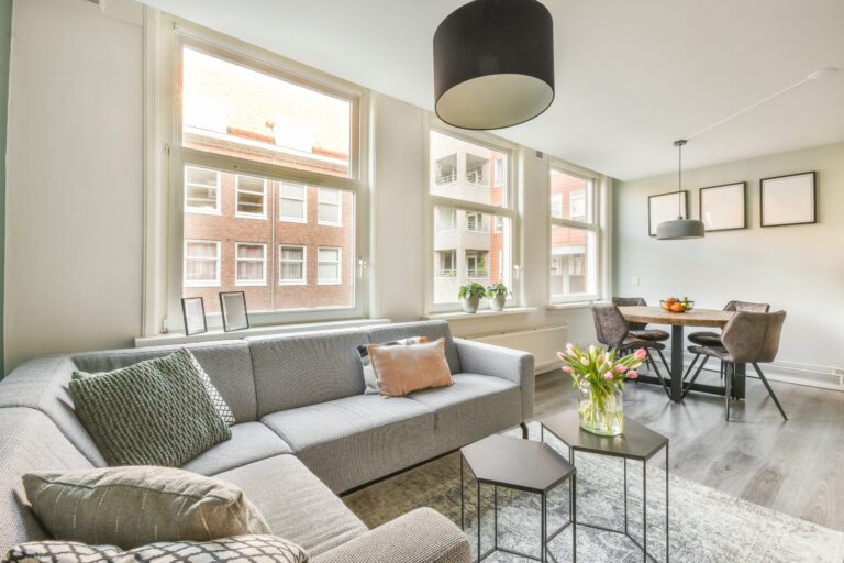 Neue Förderung für Umwandlung von Büros in Wohnungen spacious attic room with sofa kitchen scaled Versicherungspapa