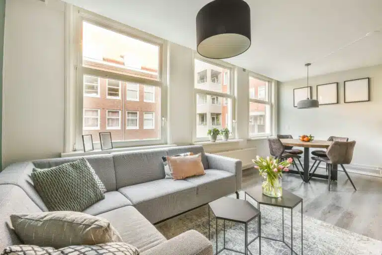 Neue Förderung für Umwandlung von Büros in Wohnungen spacious attic room with sofa kitchen scaled Versicherungspapa